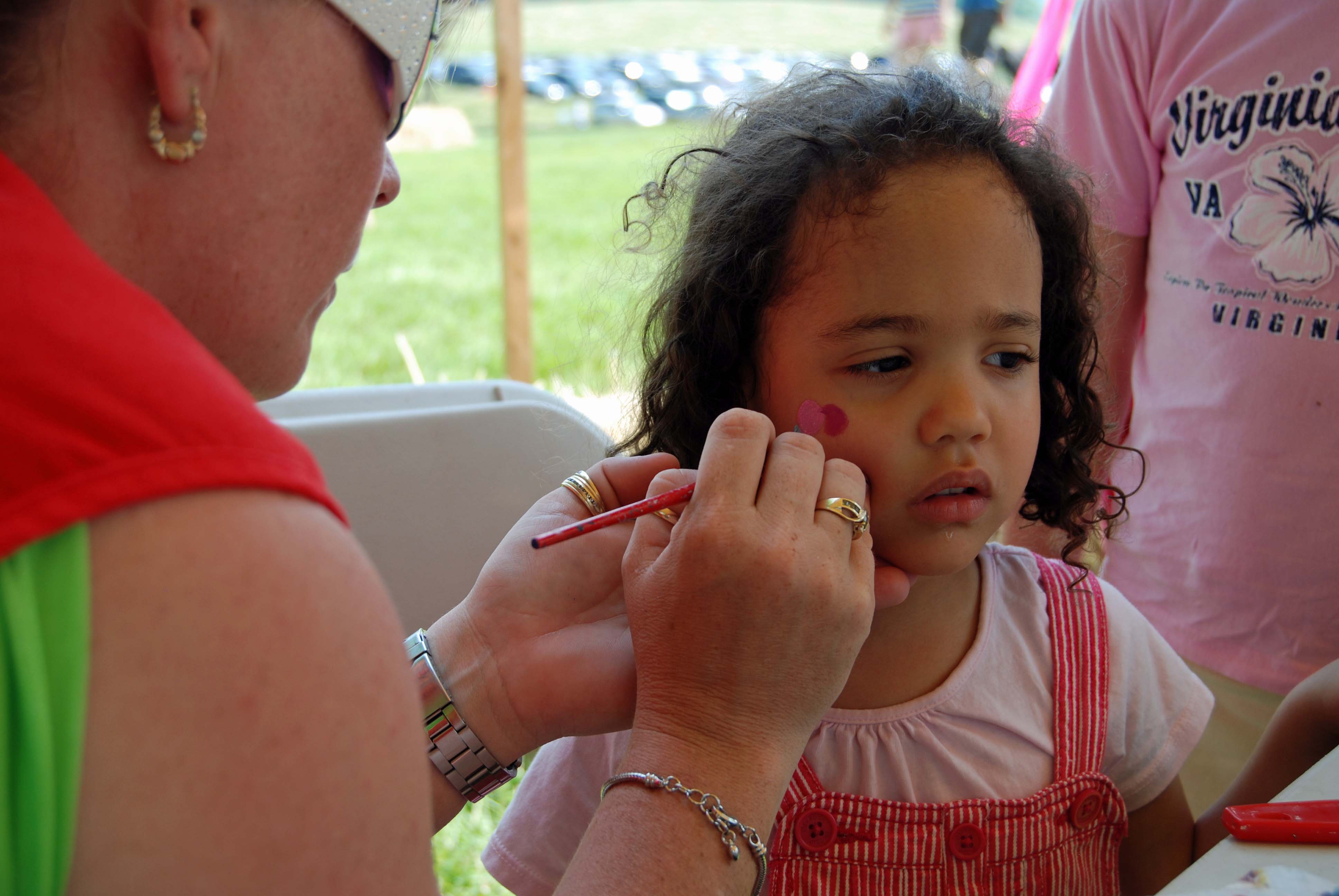 Face painting at an outdoor festival in the Ottawa area