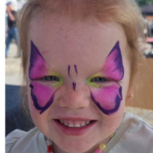 Girl with vibrant pink butterfly face paint by Maryam Fitzgerald — Flutter Face Paint, Ottawa