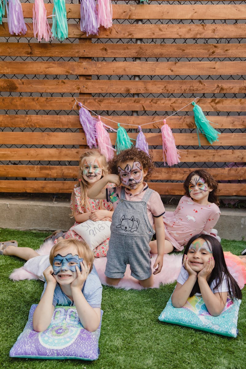 Children with superhero face paint at a birthday party in Ottawa