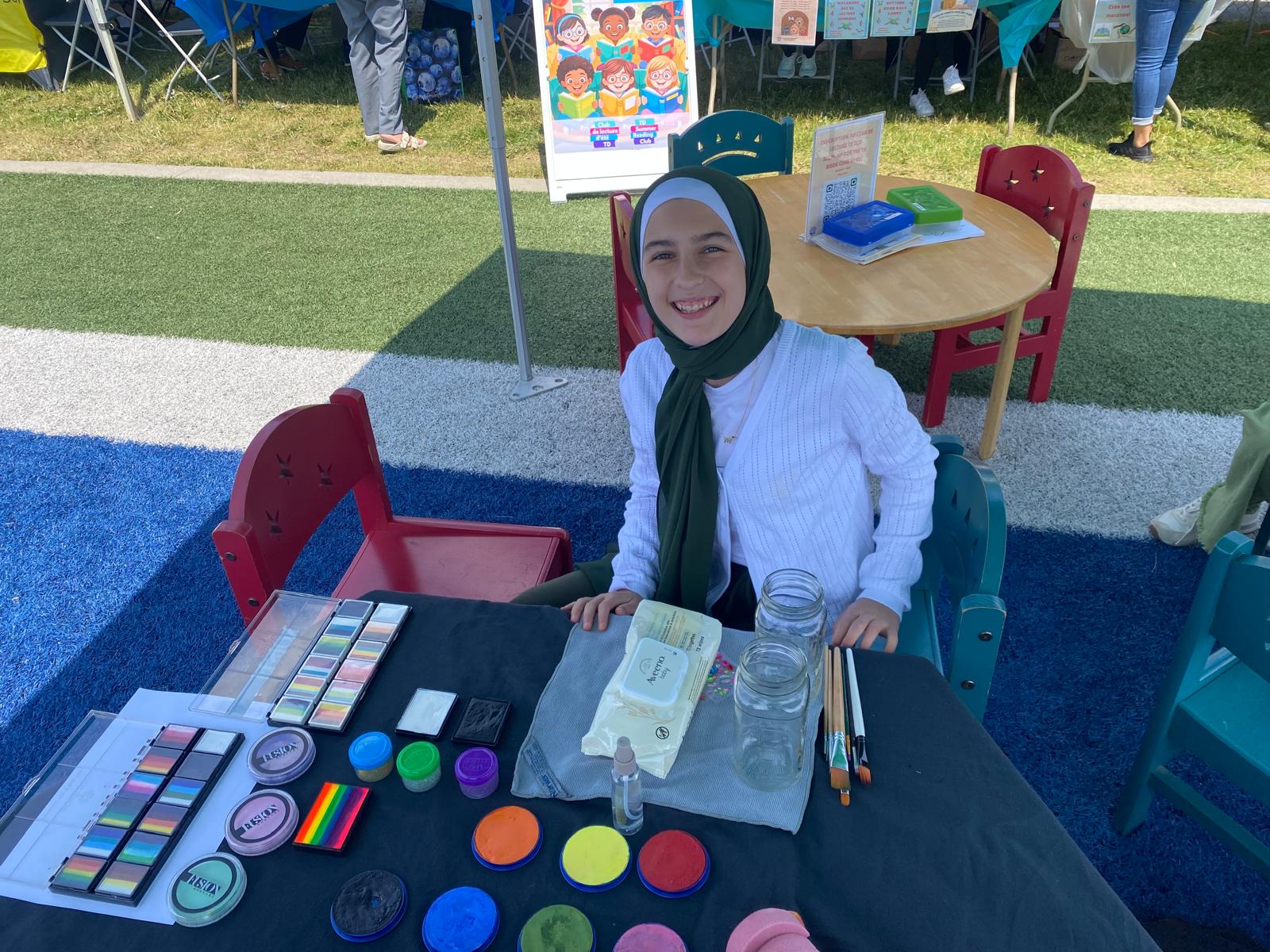 Maryam Fitzgerald, professional face painter, at her colourful booth in Kanata, Ontario