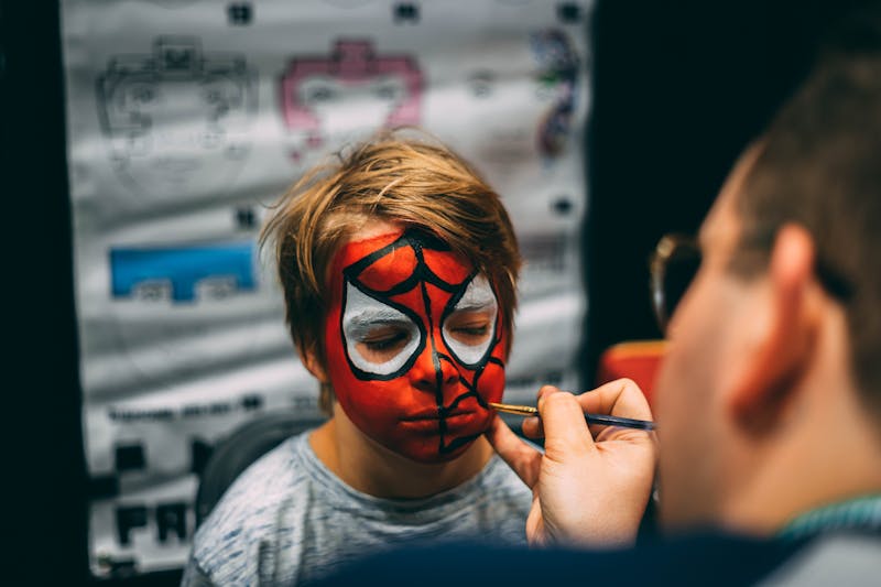 Face painting a boy at a birthday party in the Ottawa area